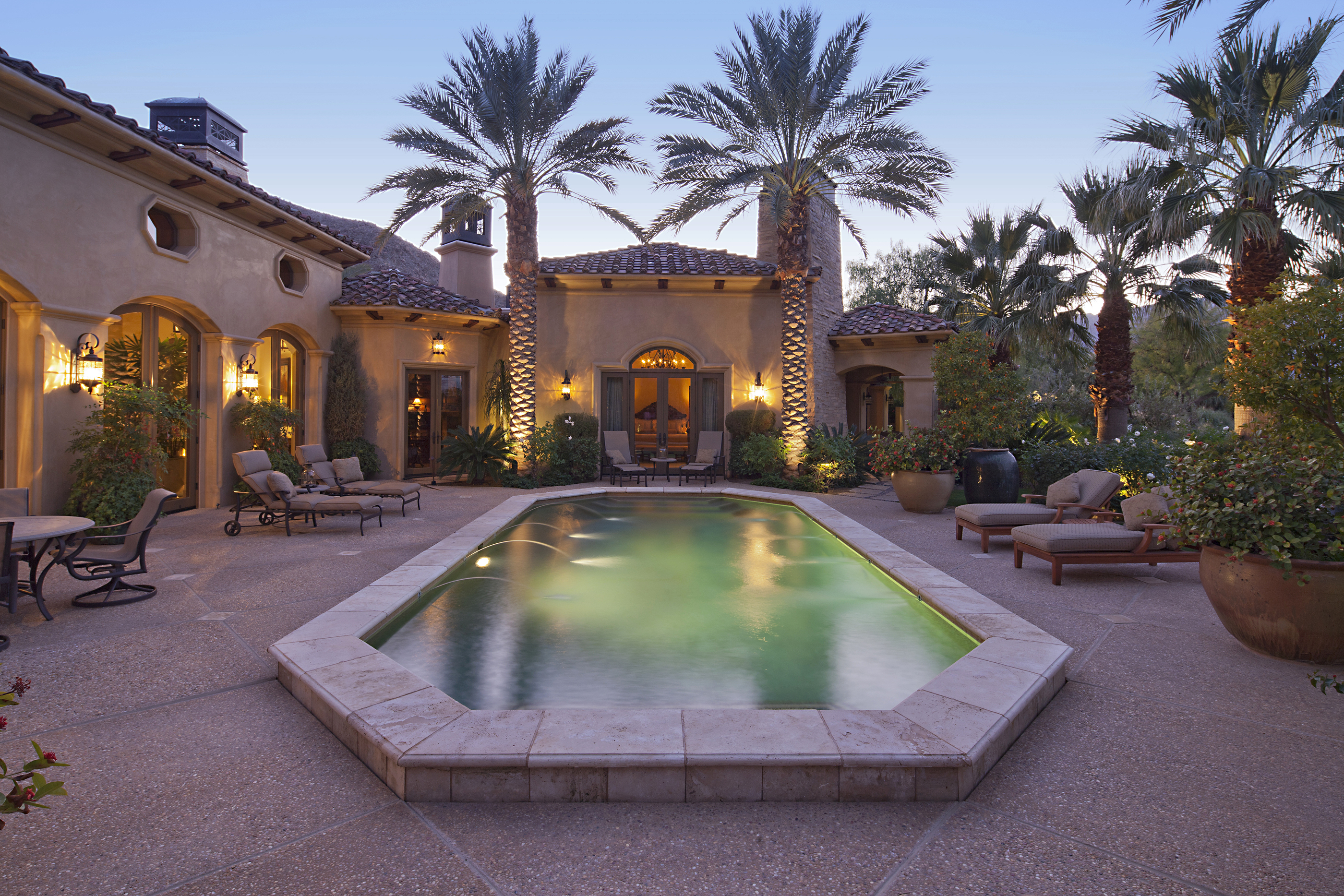 Rear entrance of luxury  villa  at night  with swimming pool 